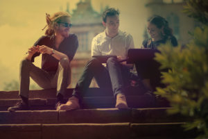 Three people sitting on steps