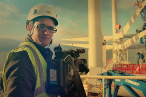 Man in hard hat with camera