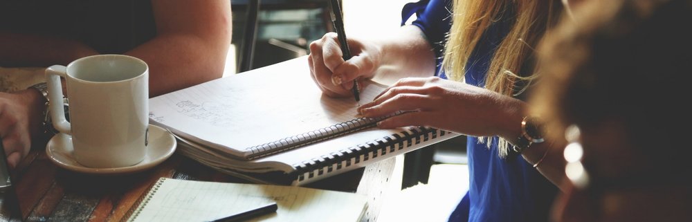 Person writing in a notepad